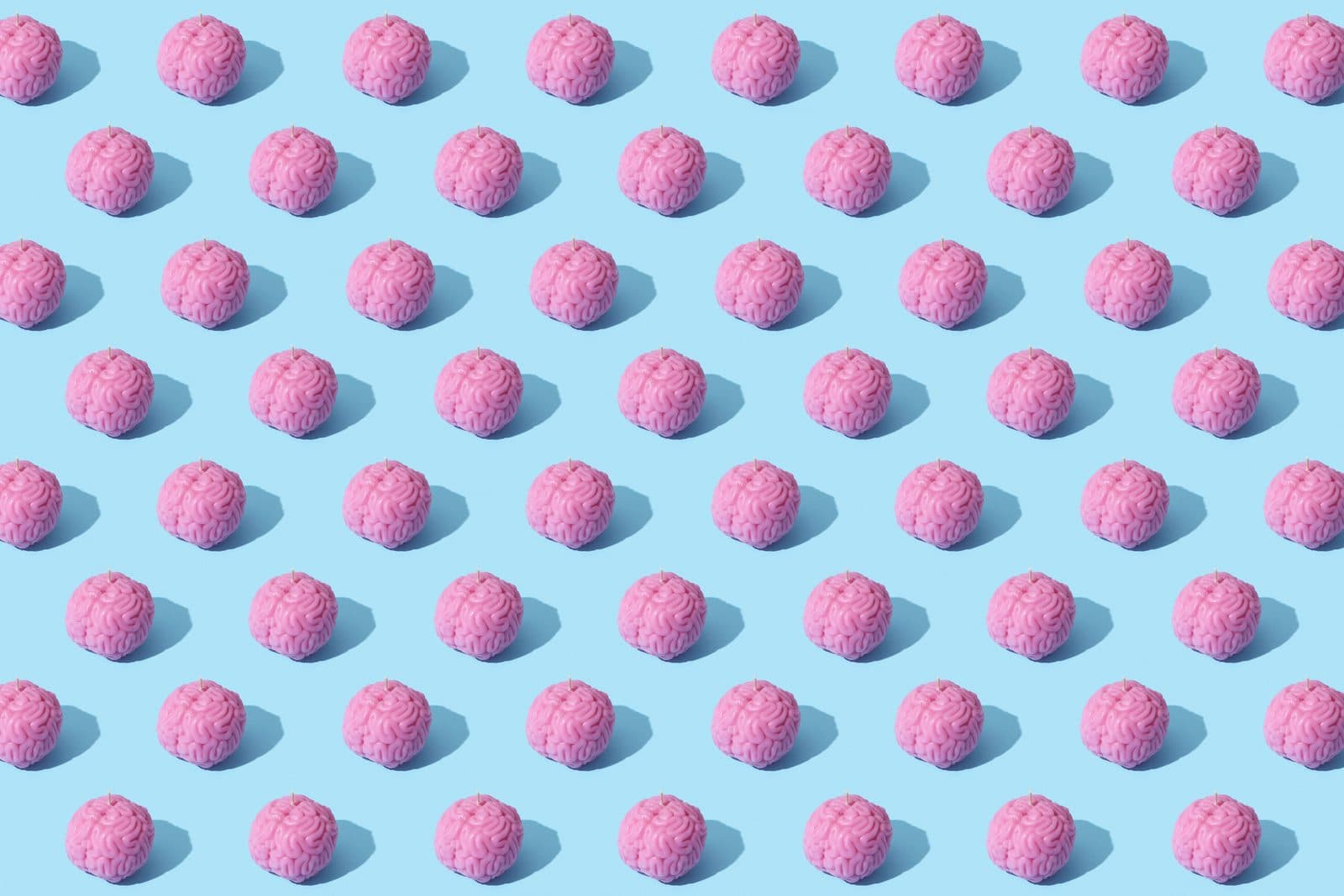A repeating pattern of pink brain candles
