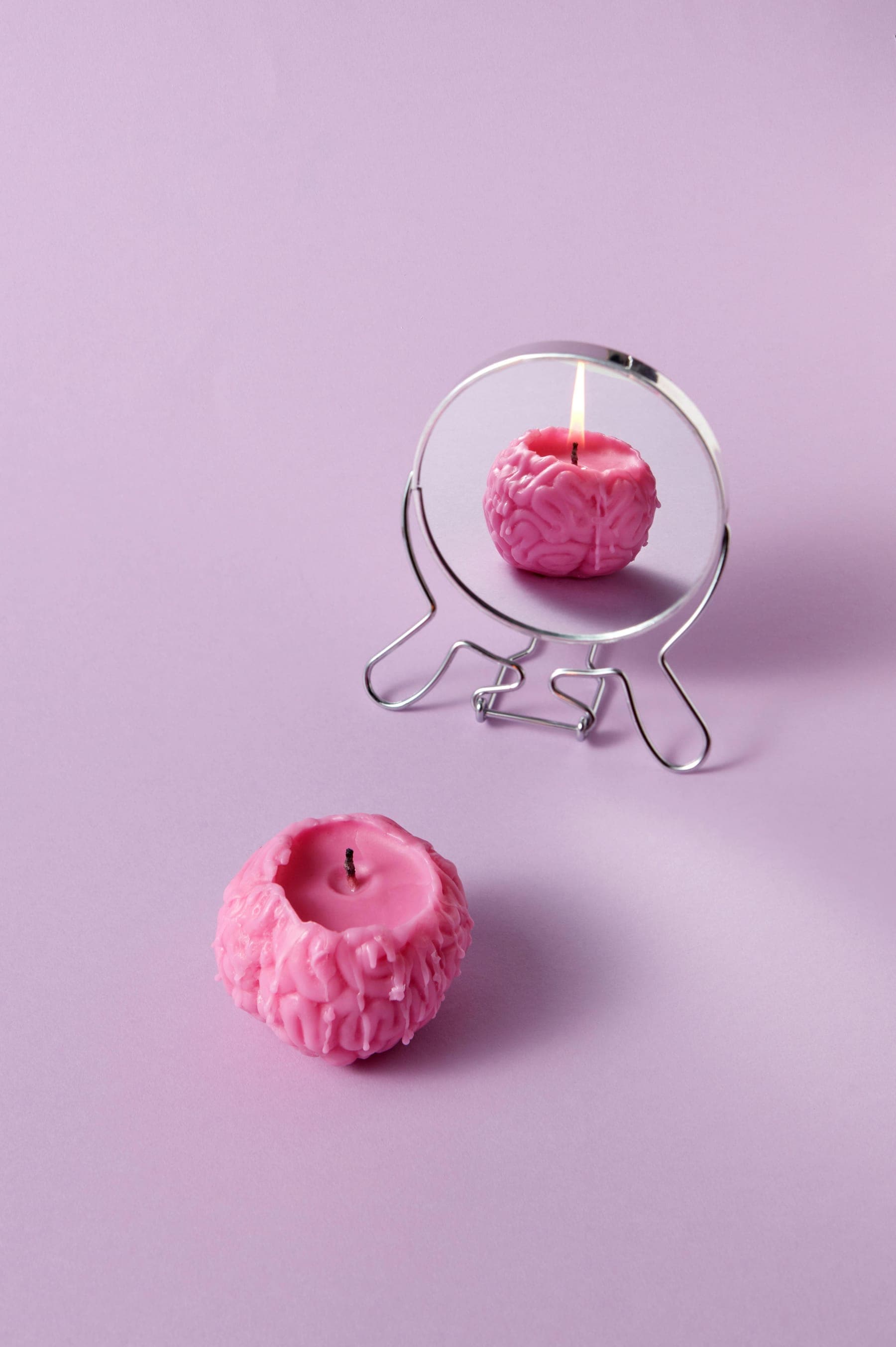 A pink brain as a candle โ the spark of potential waiting to be ignited